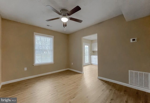 unfurnished room featuring light hardwood / wood-style flooring and ceiling fan