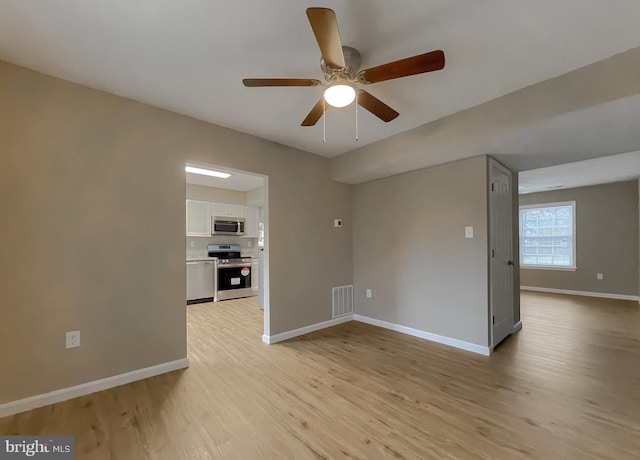 unfurnished living room featuring light hardwood / wood-style flooring and ceiling fan