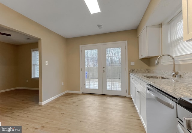 kitchen with sink, white cabinets, stainless steel appliances, light stone countertops, and french doors