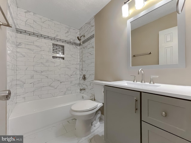 full bathroom featuring vanity, a textured ceiling, tiled shower / bath combo, and toilet