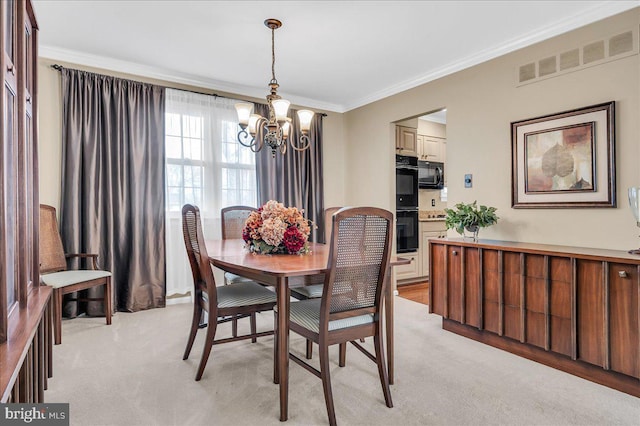 dining space featuring light carpet, a notable chandelier, and crown molding