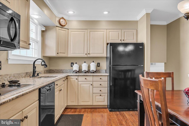 kitchen with crown molding, sink, light hardwood / wood-style floors, and black appliances