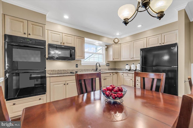 kitchen with crown molding, cream cabinetry, and black appliances