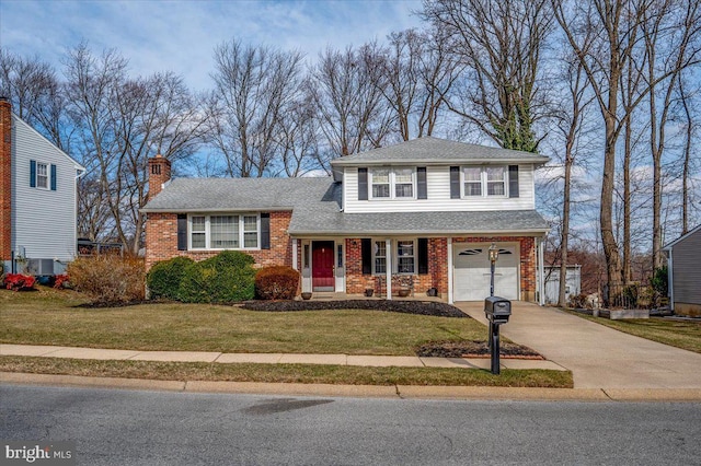 split level home featuring a garage and a front lawn