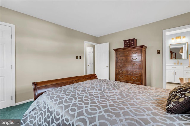 bedroom featuring ensuite bathroom and carpet