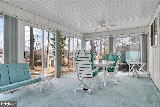 unfurnished sunroom with ceiling fan and a healthy amount of sunlight