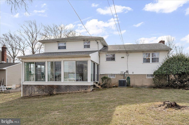 rear view of property featuring central AC, a yard, and a sunroom