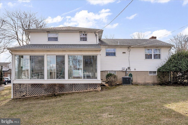 back of property with a sunroom, a yard, and cooling unit