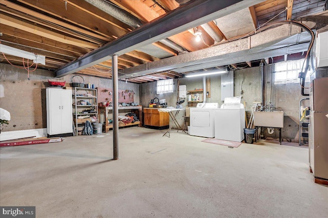 basement featuring sink and washing machine and clothes dryer