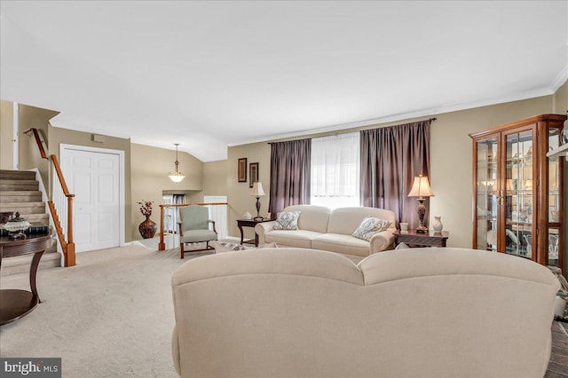 living room with crown molding, lofted ceiling, and carpet flooring