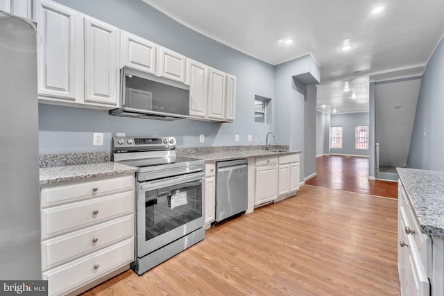 kitchen with sink, stainless steel appliances, white cabinets, and light wood-type flooring