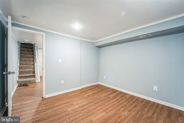 unfurnished room with crown molding and light hardwood / wood-style flooring