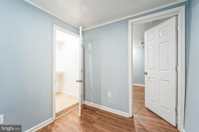 unfurnished bedroom featuring hardwood / wood-style flooring and ornamental molding