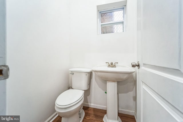 bathroom with hardwood / wood-style floors and toilet