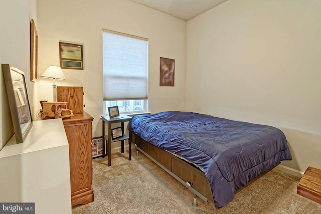 bedroom featuring light carpet