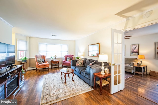 living room with dark hardwood / wood-style flooring, crown molding, and baseboard heating