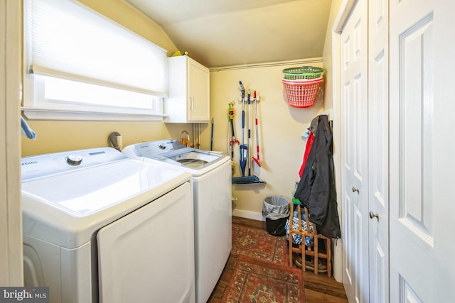 laundry area with separate washer and dryer and cabinets