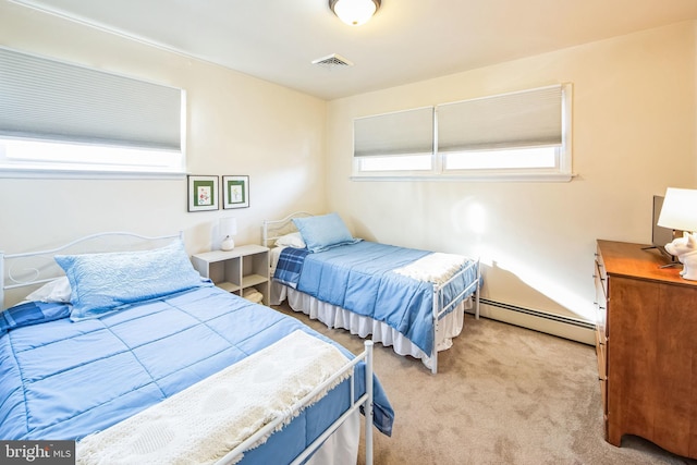 carpeted bedroom featuring baseboard heating