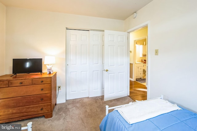 bedroom with light carpet and a closet