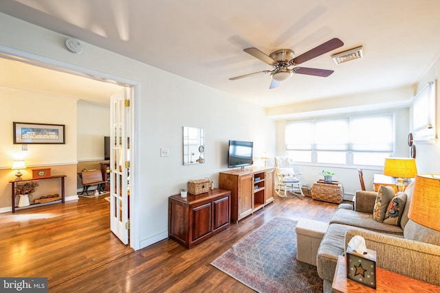 living room with dark hardwood / wood-style floors and ceiling fan