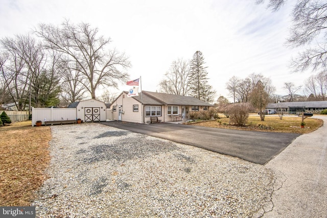 view of front of house featuring a storage shed