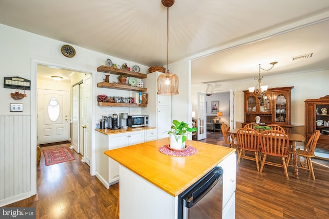 kitchen with white cabinetry, a kitchen island, dark wood-type flooring, and pendant lighting