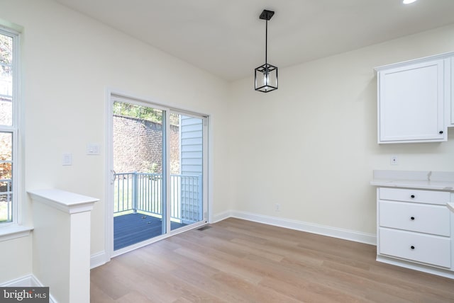 unfurnished dining area with a healthy amount of sunlight and light hardwood / wood-style floors