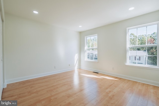 empty room with light hardwood / wood-style flooring