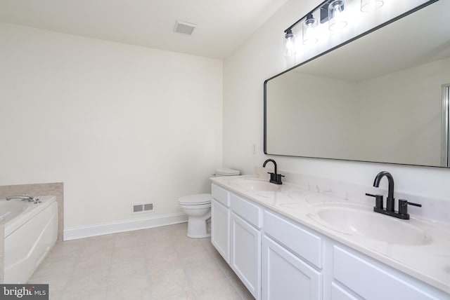 bathroom with vanity, a bathing tub, and toilet