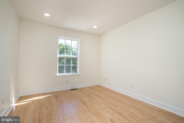 spare room with light hardwood / wood-style flooring