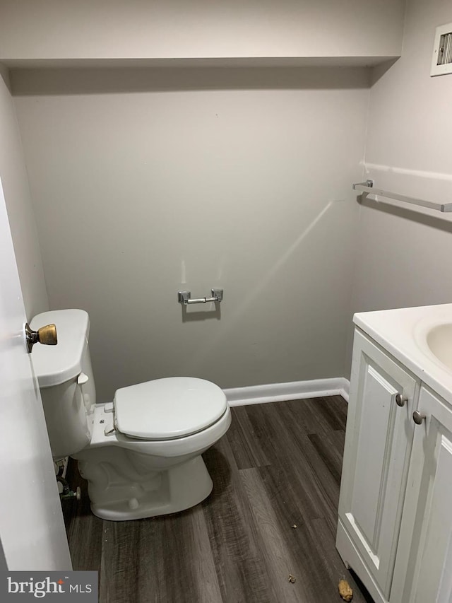 bathroom featuring vanity, toilet, and hardwood / wood-style floors