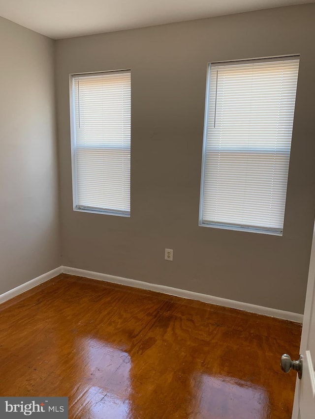 spare room featuring hardwood / wood-style flooring