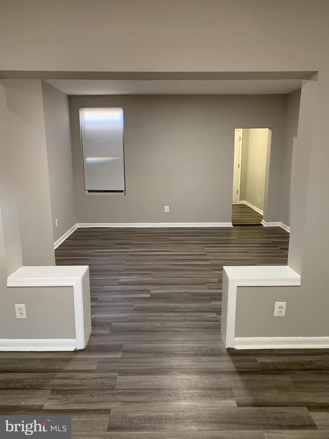 spare room featuring dark wood-type flooring