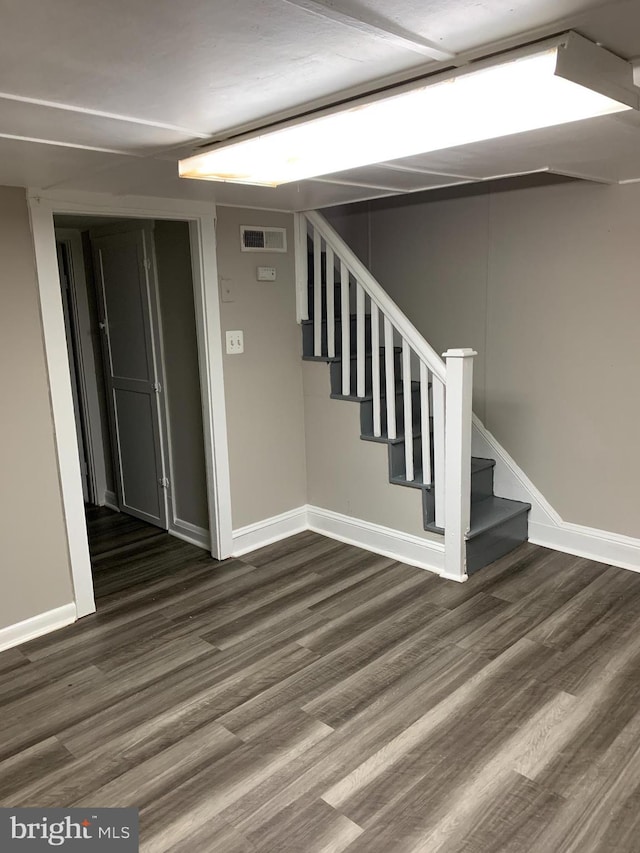 basement featuring dark hardwood / wood-style flooring