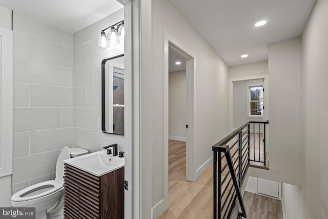 bathroom featuring vanity, hardwood / wood-style floors, and toilet