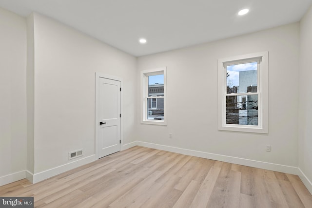 unfurnished room with light wood-type flooring