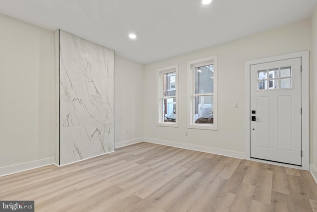 foyer entrance with plenty of natural light and light hardwood / wood-style flooring