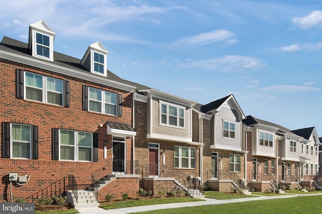 townhome / multi-family property with brick siding and a residential view