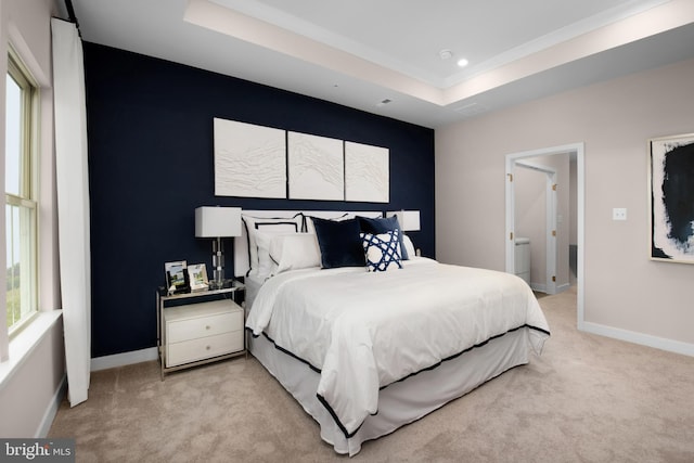 bedroom with recessed lighting, a tray ceiling, light carpet, and baseboards