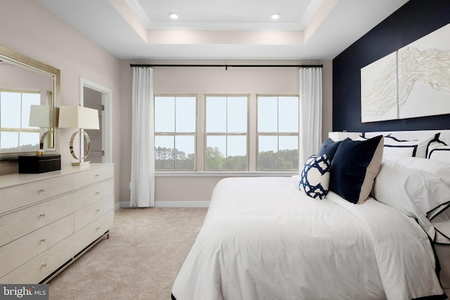 bedroom featuring recessed lighting, light colored carpet, baseboards, and a tray ceiling