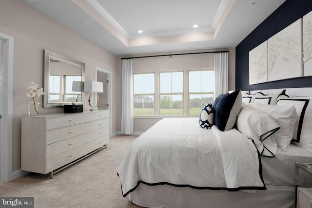 bedroom featuring recessed lighting, light colored carpet, baseboards, and a tray ceiling