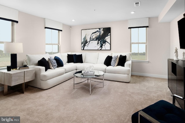 carpeted living area with recessed lighting, baseboards, and visible vents