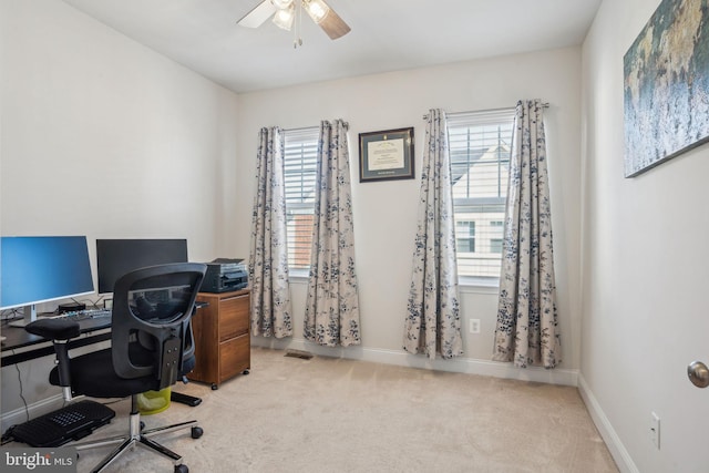 home office featuring a ceiling fan, carpet, baseboards, and a healthy amount of sunlight