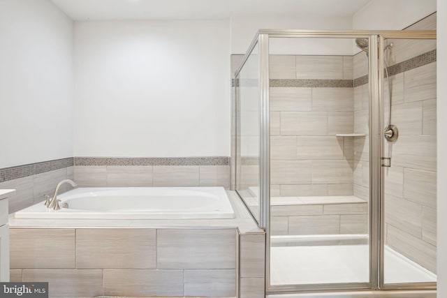 bathroom featuring a garden tub and a stall shower