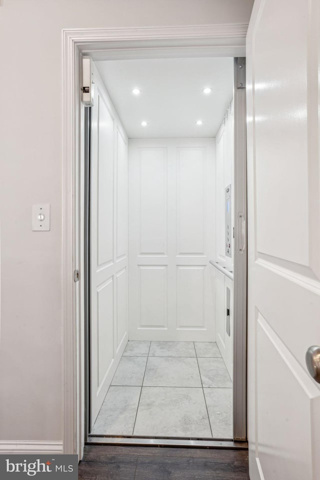 interior space with elevator and recessed lighting