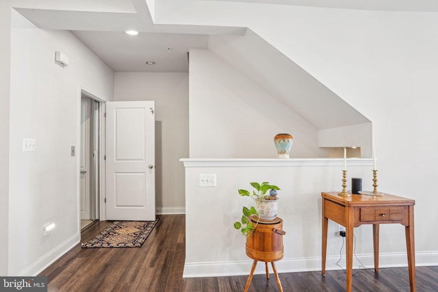 hallway featuring wood finished floors and baseboards