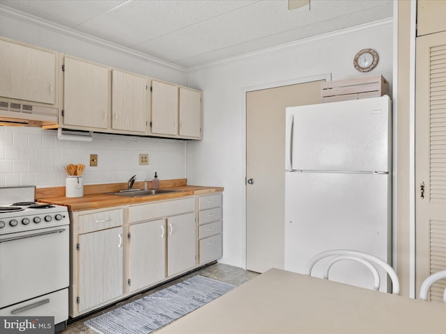 kitchen with sink, white appliances, and ornamental molding