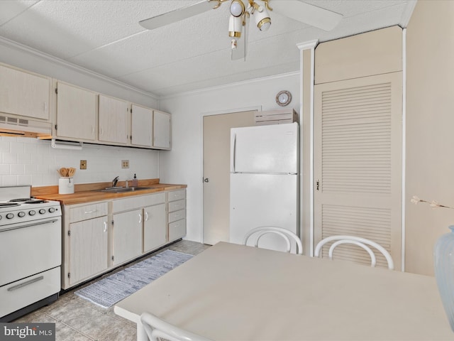 kitchen with crown molding, sink, white appliances, and backsplash