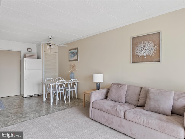 living room featuring crown molding and ceiling fan