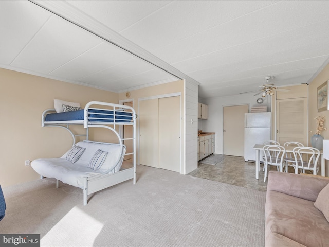 bedroom with vaulted ceiling, a closet, and white refrigerator